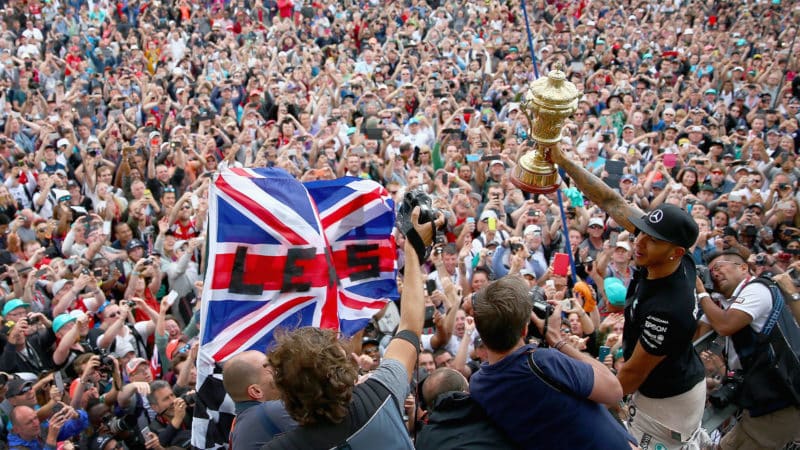 Lewis Hamilton lifts his winning trophy in front of the Silverstone crowd after the 2015 British Grand Prix