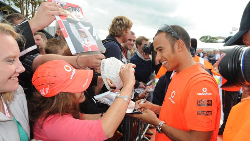 Lewis Hamilton signs autographs with fans after winning the 2008 British Grand Prix