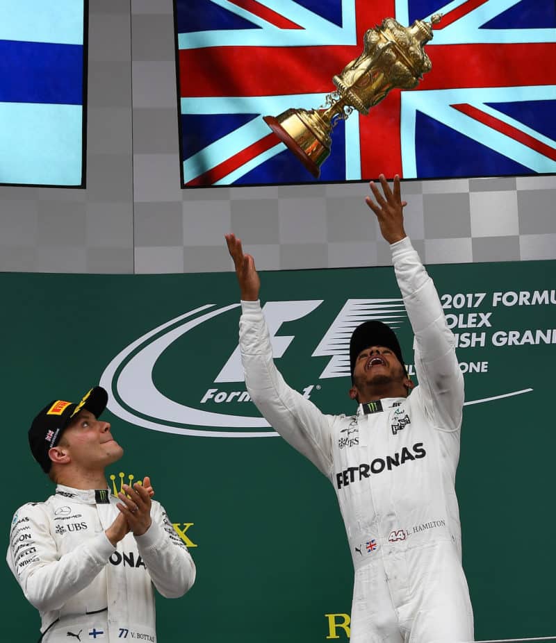 Lewis-Hamilton-throws-the-RAC-trophy-in-the-air-after-winning-the-2017-British-Grand-Prix