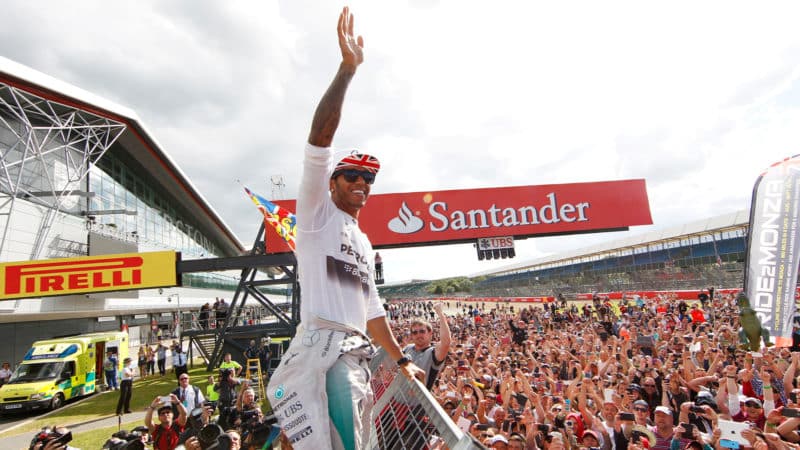 Lewis Hamilton waves to the crowd at the 2014 British Grand Prix