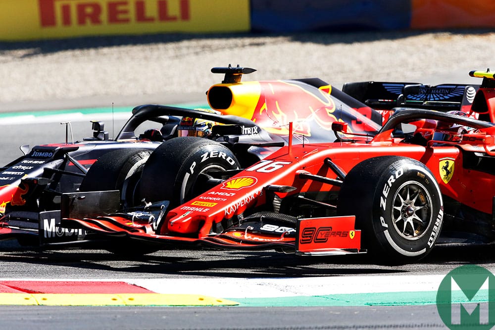 Max Verstappen's Red Bull passes Charles Leclerc's Ferrari late in the 2019 Austrian Grand Prix