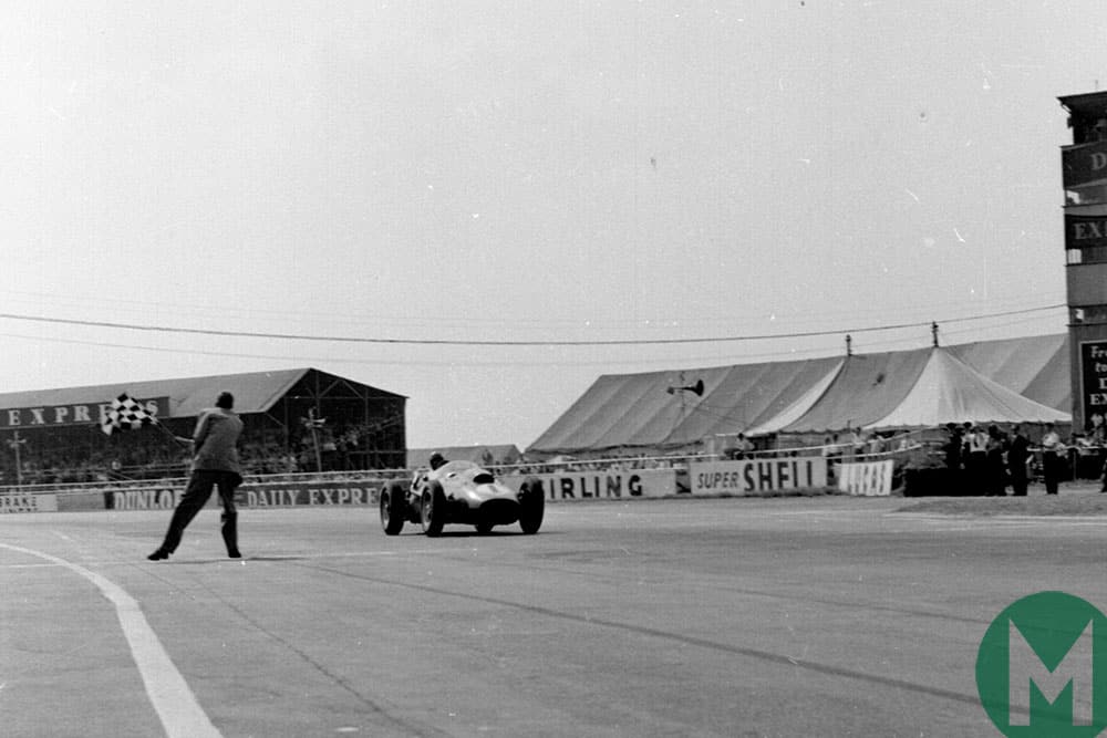 Peter Collins' Ferrari takes the flag in the 1958 British Grand Prix