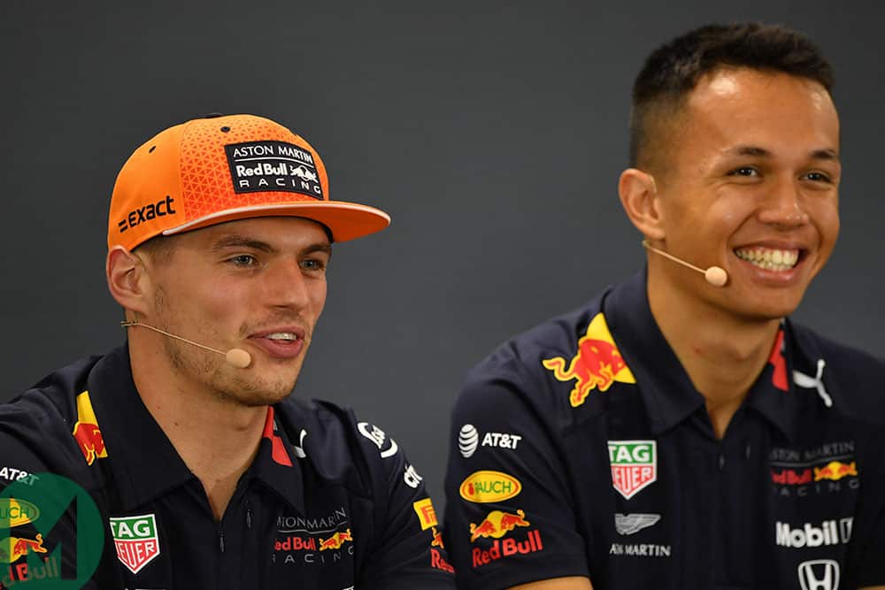 Max Verstappen and Alexander Albon smiling at a pre-2019 Belgian Grand Prix press conference