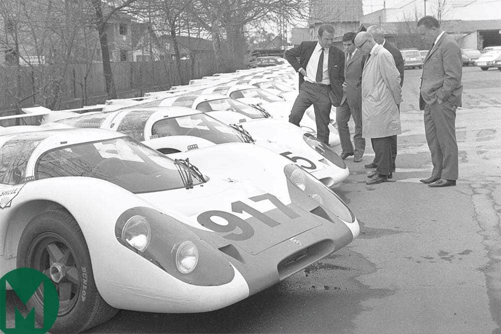 Ferdinand Piëch stands next to 25 Porsche 917s built in accordance with FIA homologation rules
