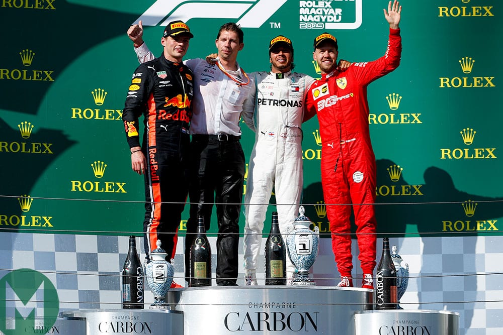Verstappen, Mercedes' chief strategist James Vowles, Hamilton and Ferrari's Sebastian Vettel celebrate on the podium