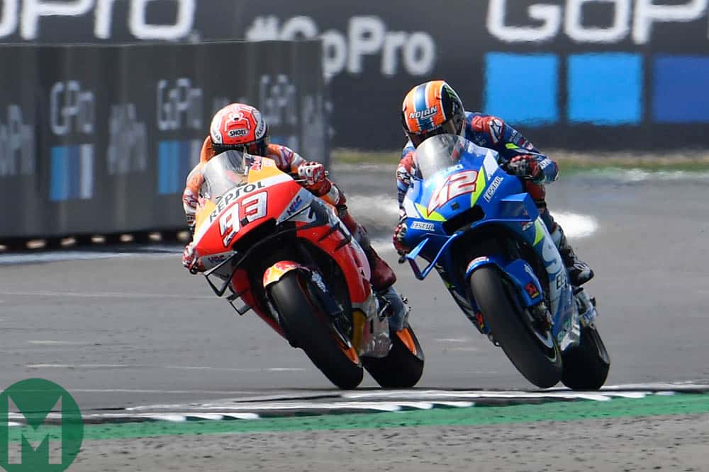 Rins attempts to overtake Marquez on the outside of Woodcote at the 2019 MotoGP British Grand Prix