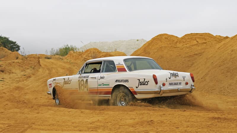 Rolls Royce Dakar car drives in sand