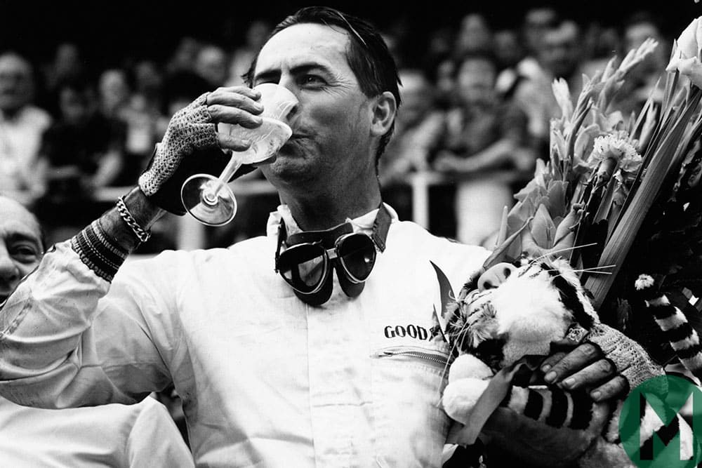 Jack Brabham drinks champagne after winning the 1966 French Grand Prix in Reims