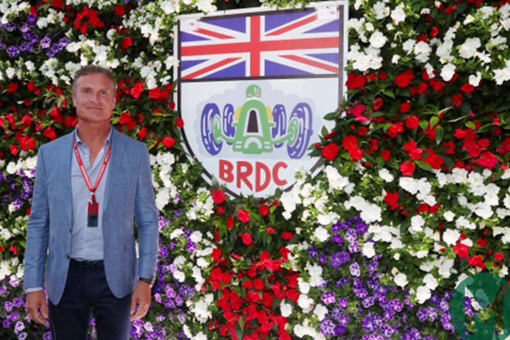 David Coulthard standing in front of a BRDC logo
