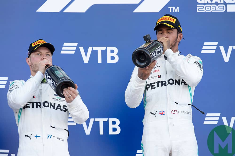 Lewis Hamilton and Valtteri Bottas drink champagne on the podium at the 2019 F1 Russian Grand Prix