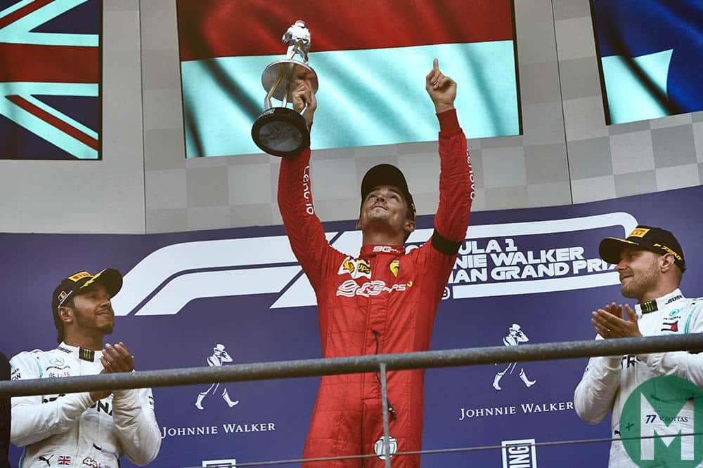 Charles Leclerc raises his trophy and finger to the sky in memory of Anthoine Hubert at the 2019 F1 Belgian Grand Prix