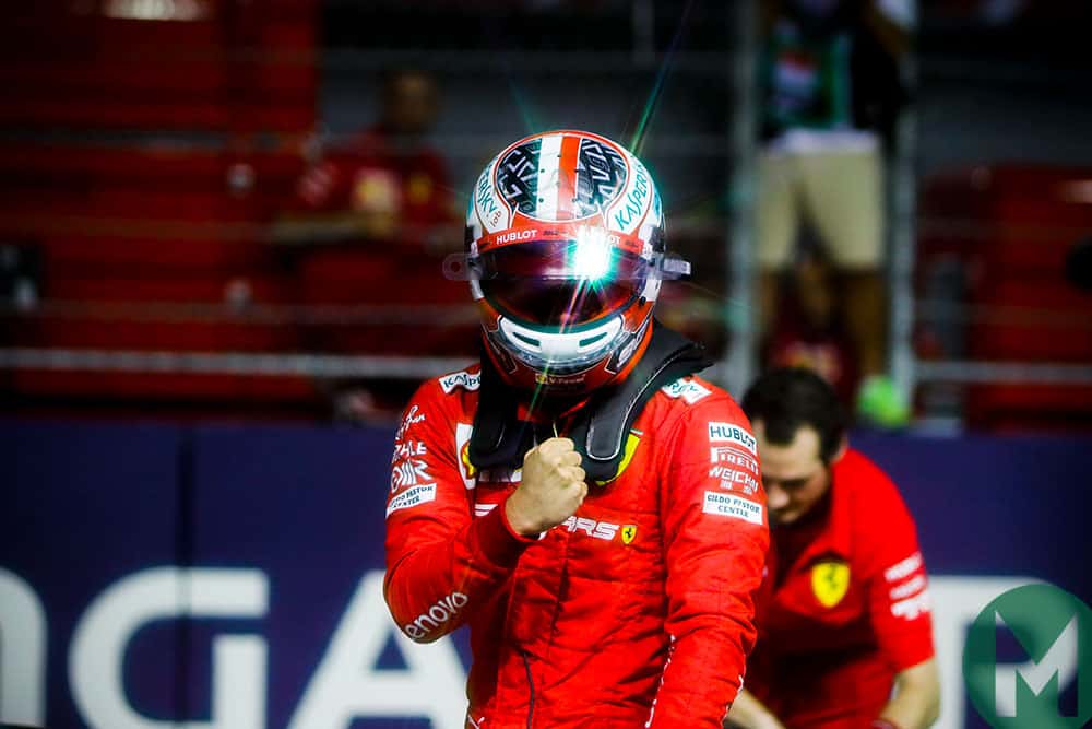Charles Leclerc pumps his fist after securing pole position during qualifying for the 2019 f1 Singapore Grand Prix