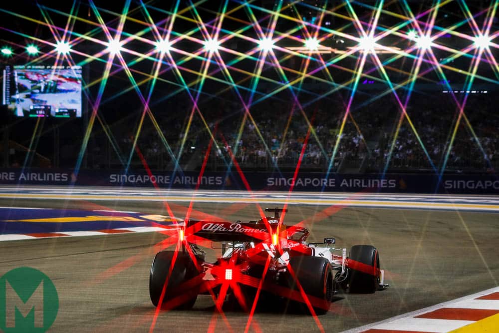 The red rear lights of an Alfa Romeo combine with the circuit's floodlights at the 2019 F1 Singapore Grand Prix