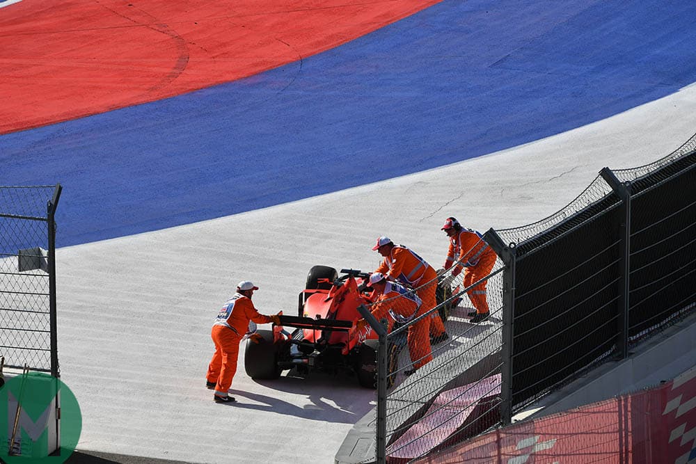 Marshals wheel Sebastian Vettel's car away after he retired from the 2019 F1 Russian Grand Prix