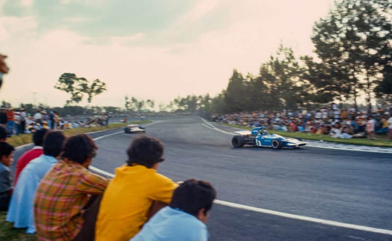 Crowd on the edge of the circuit watch Matra of Jean-Pierre Beltoise in 1970 Mexican Grand Prix
