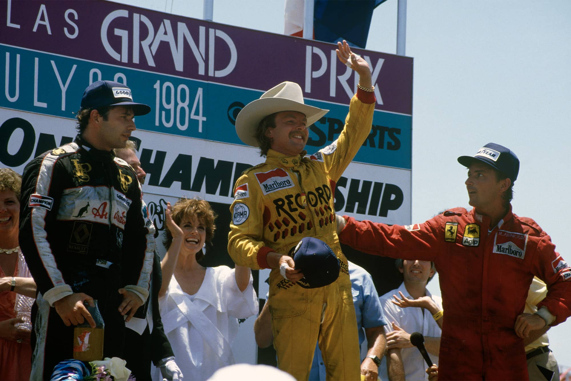 Keke Rosberg stands atop the podium after winning the 1984 Dallas Grand Prix