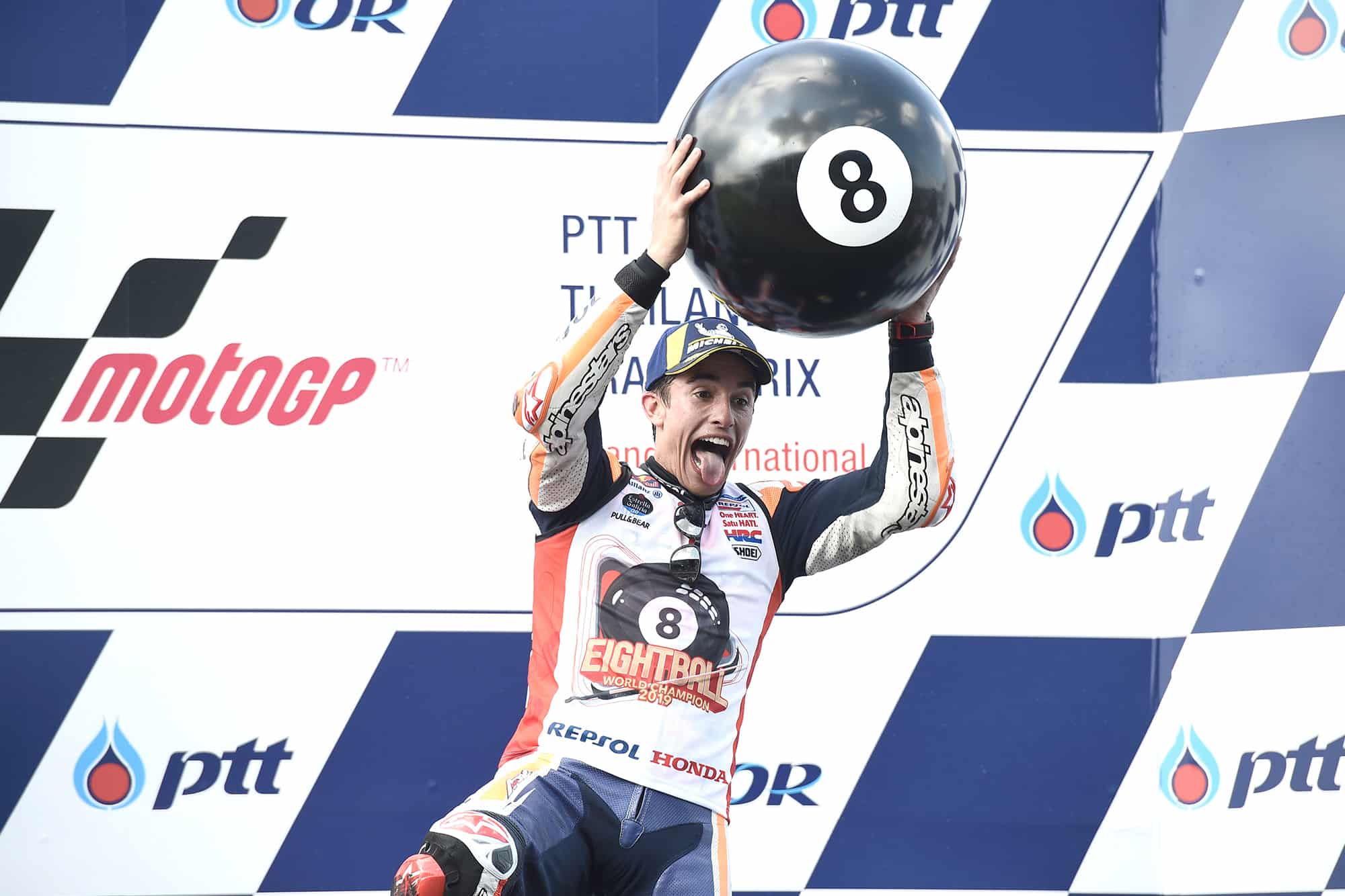 Marx Marquez on the podium with an 8 ball at the 2019 Thailand MotoGP race, after winning his sixth MotoGP title