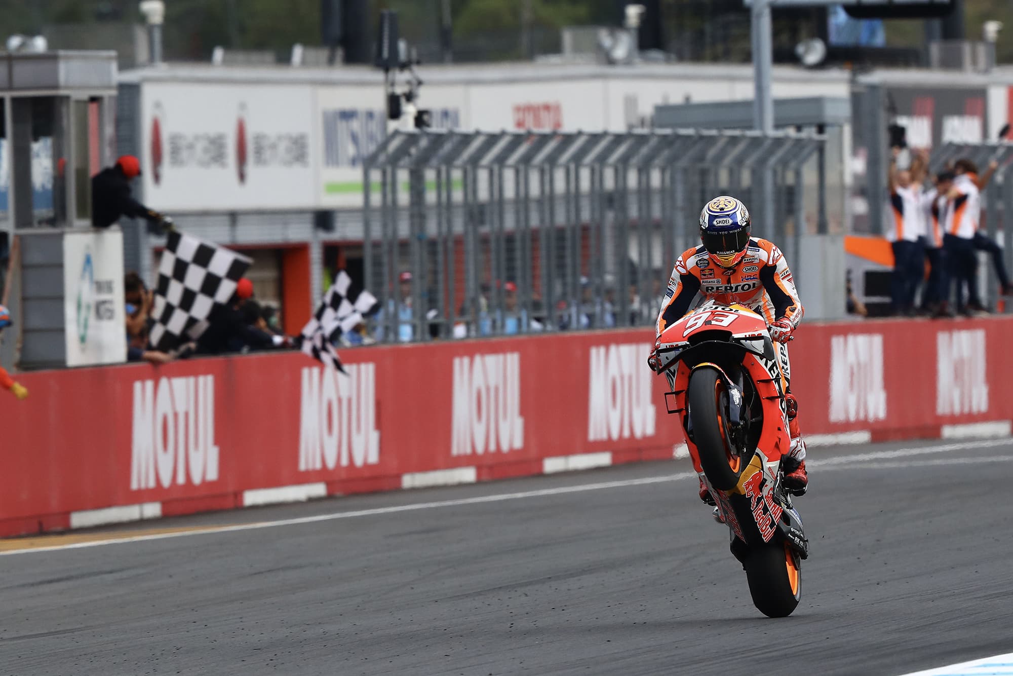 Marc Marquez takes the chequered flag with a wheelie to win the 2019 MotoGP Grand Prix of Japan
