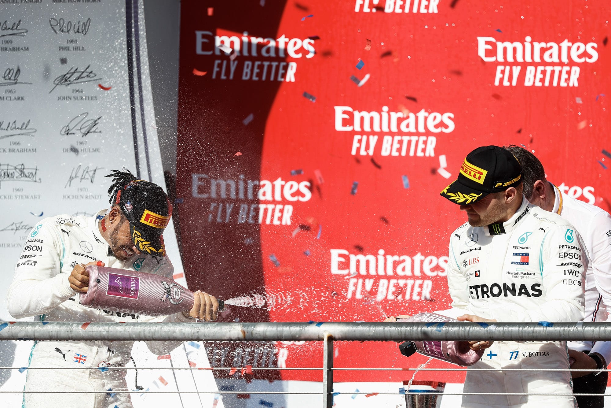 Lewis Hamilton and Valtteri Bottas spray champagne on the podium after the 2019 United States Grand Prix