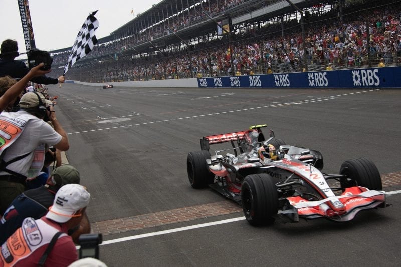 Lewis Hamilton crosses the brick-lined finish line to win the 2007 US Grand Prix at Indianapolis