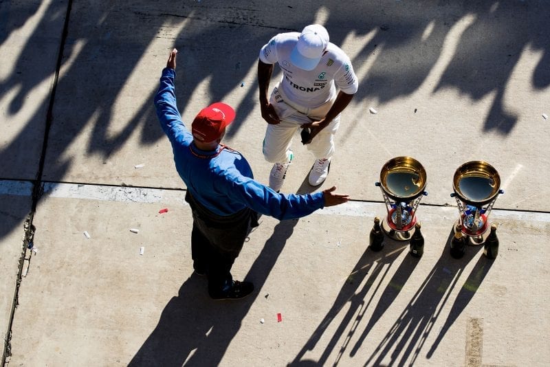 Overhead shot of Niki Lauda holding his arms wide as Lewis Hamilton walks up after the 2017 US Grand Prix