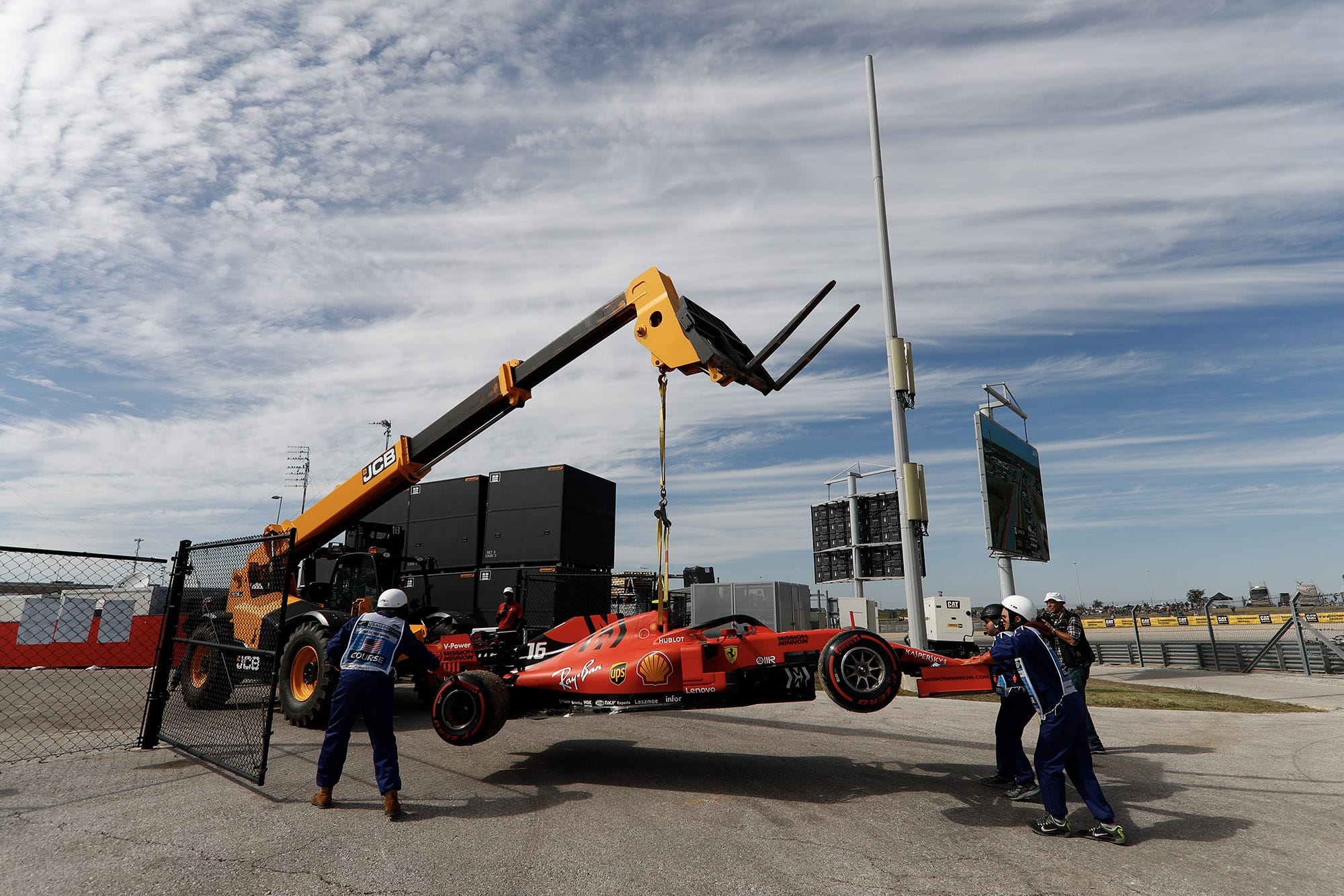 Charles Leclerc's car is lifted away from the circuit at the 2019 United States Grand Prix after suffering an oil leak during practice