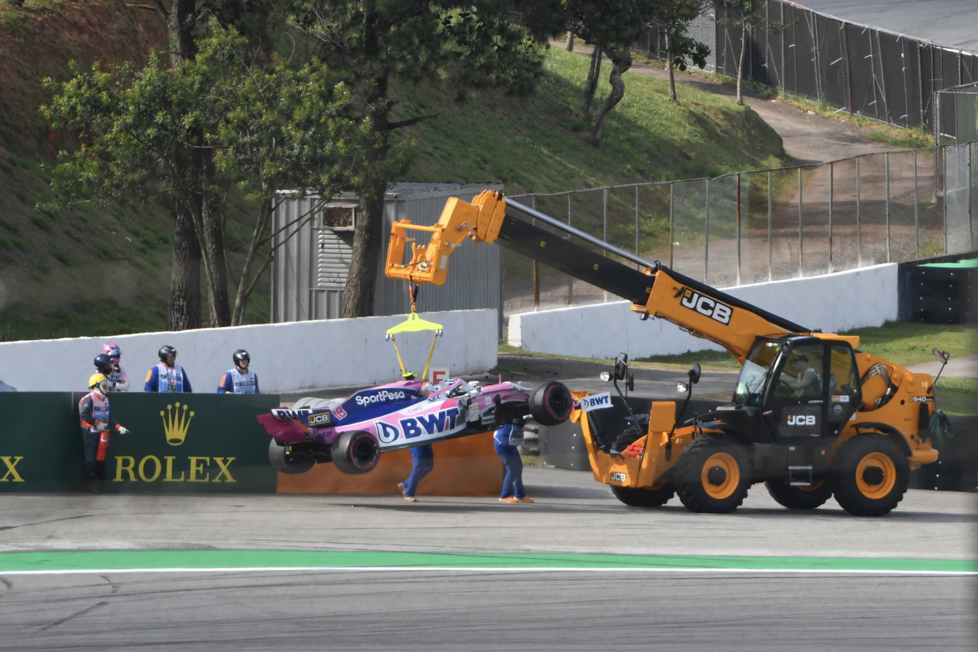 Lance Stroll's Racing Point is hoisted away by a tractor during the 2019 Brazilian Grand Prix