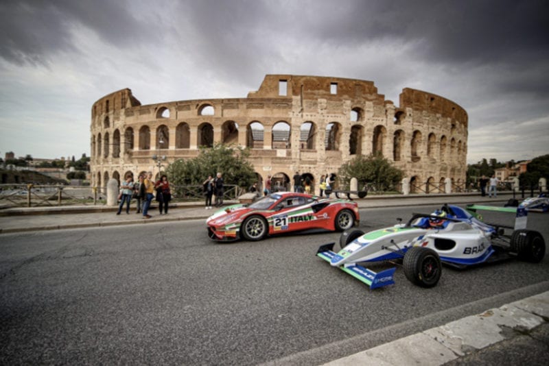 A single-seater and GT car drives in front of Rome's Colosseum ahead of the 2019 Motorsport Games