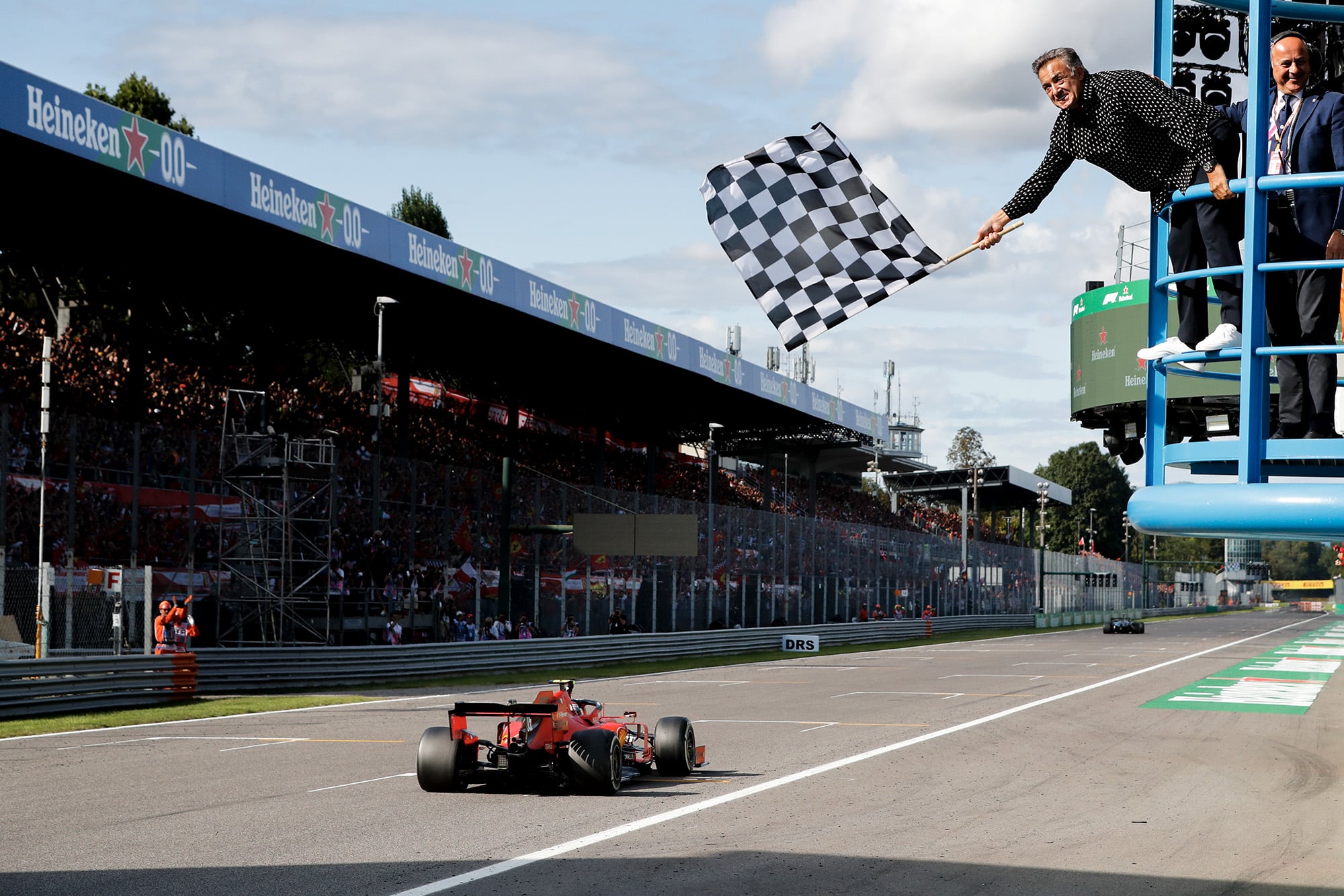 Jean Alesi waves the chequered flag at the 2019 Italian Grand Prix