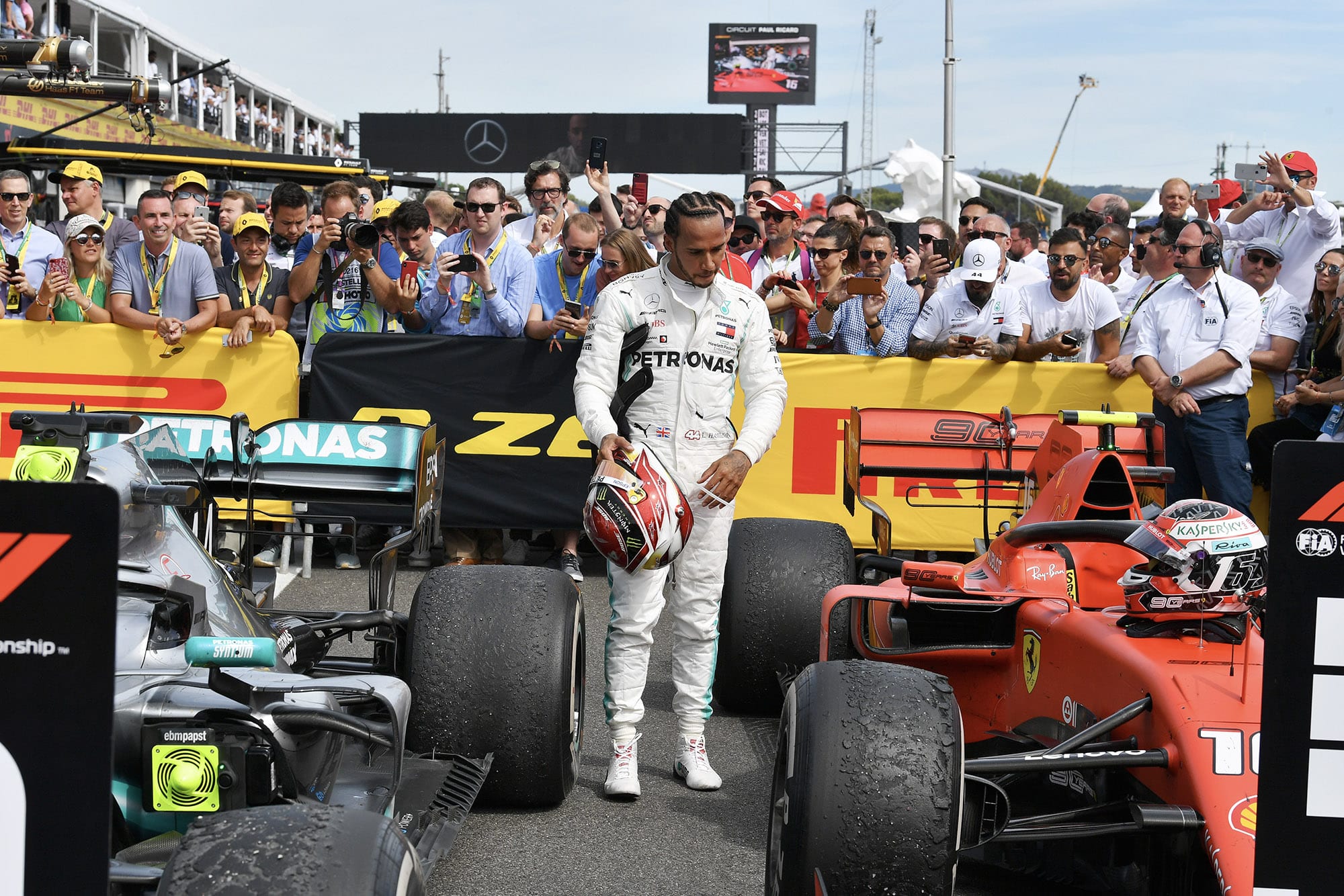 Lewis Hamilton looks at Charles Leclerc's Ferrari after the 2019 French Grand prix