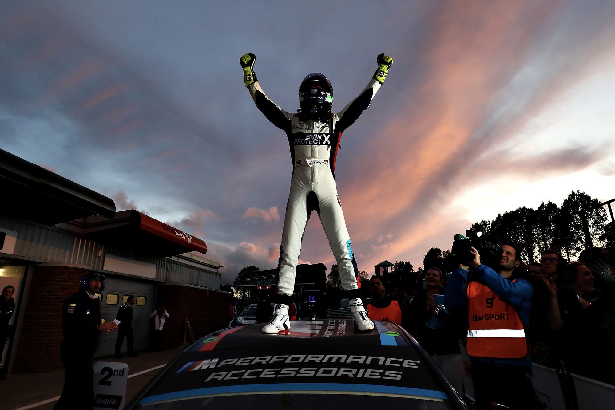 Colin Turkington stands on his car as he celebrates winning the 2019 BTCC championship at Brands Hatch