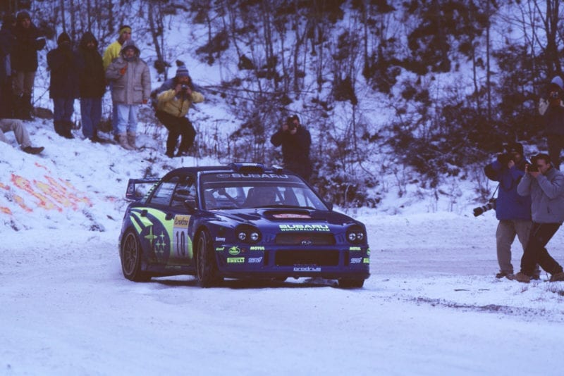 Subaru's Tommi Mäkinen slides past spectators during the 2002 Monte Carlo Rally