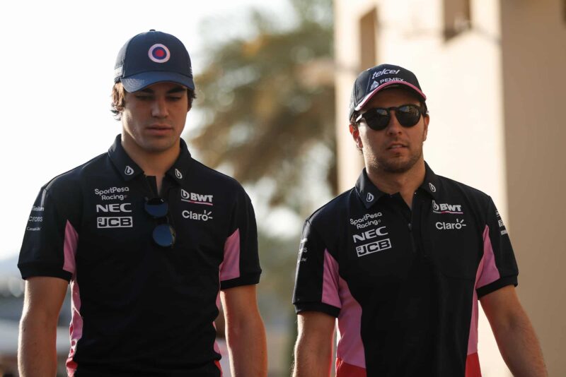 Lance Stroll and Sergio Perez walk through the paddock in the 2019 season