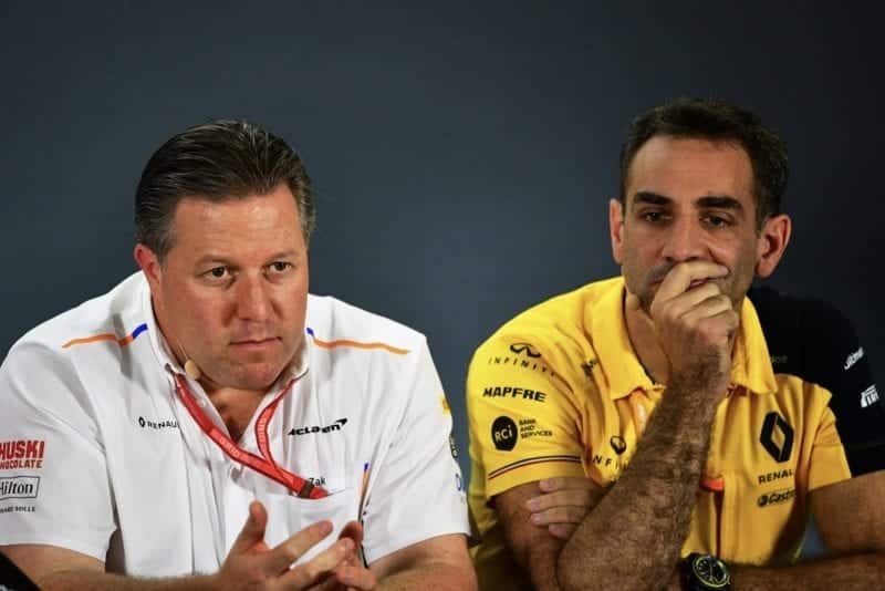 Zak Brown sitting next to Cyril Abiteboul in an F1 press conference