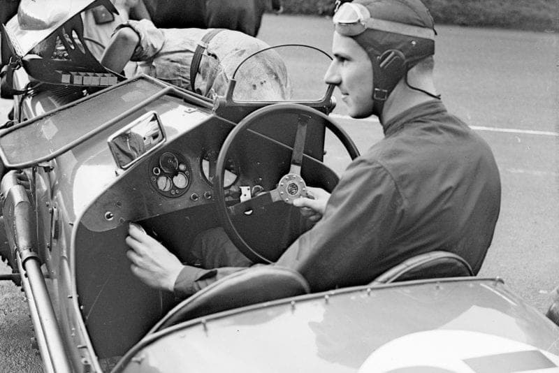 Richard Seaman (1913 - 1939) at the wireless control of an MG car during the Royal Automobile Club Tourist Trophy race practice in Belfast