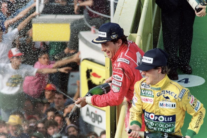 Ayrton Senna sprays champagne alongside Michael Schumacher after winning the 1992 Italian Grand Prix