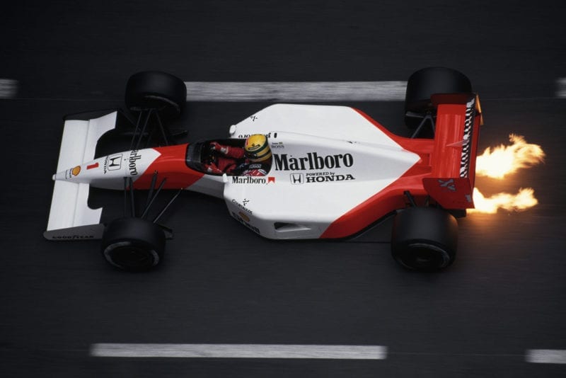 Flames shoot from underneath Ayrton Senna's McLaren Honda at the 1991 Monaco Grand Prix