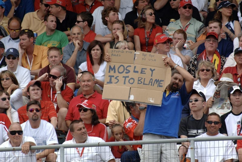 A fan holds up a Mosley is to blame sign at the 2005 United States Grand Prix