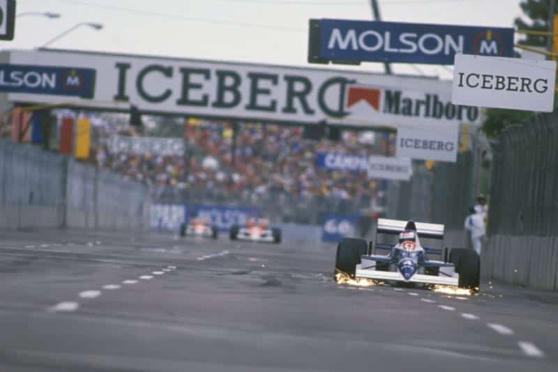 Jean Alesi's Tyrrell leads with a large gap to the chasing McLarens at the 1990 US Grand Prix