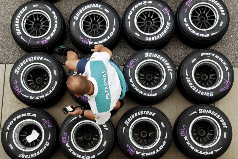 An engineer tests the pressure of Bridgestone F1 tyres