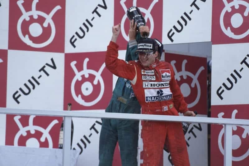 Ayrton Senna celebrates winning his first F1 world championship at the 1988 Japanese Grand Prix