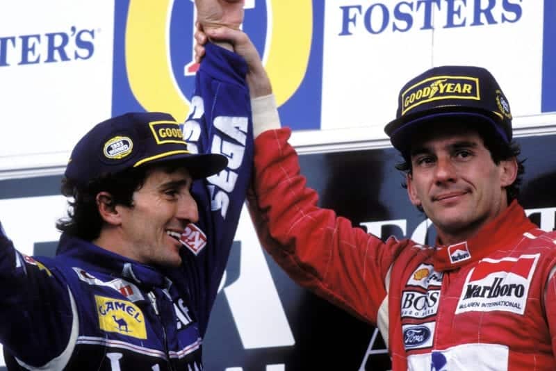 Ayrton Senna raises Alain Prost's arm in the air after winnin his final race at the 1993 Australian Grand Prix