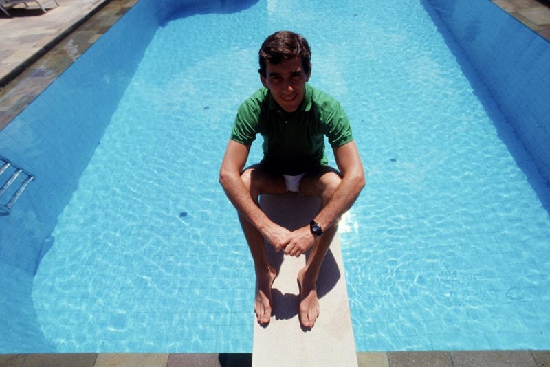 Ayrton Senna sits on the diving board of his home swimming pool