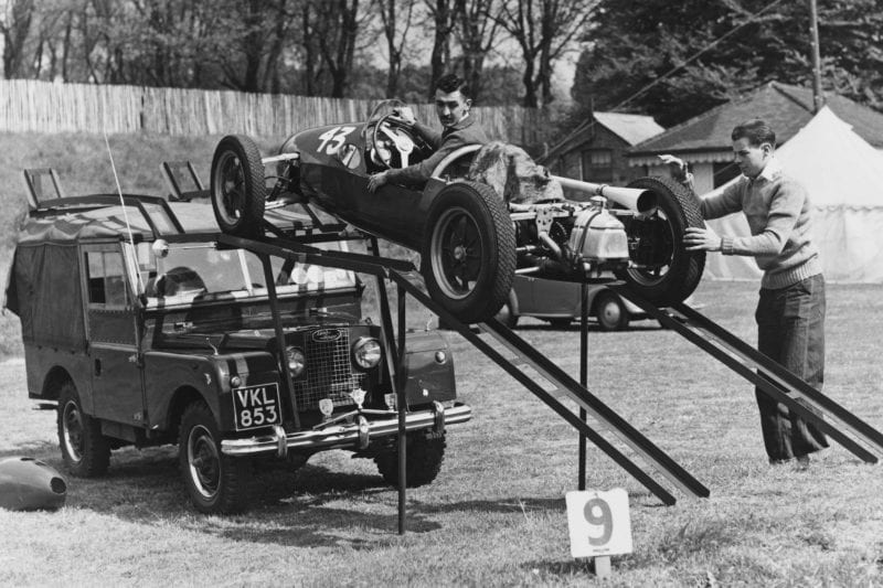 Stuart-Lewis-Evans-unloads-his-Cooper-500-F3-car-from-the-roof-of-a-Land-Rover-Series-I-in-1956