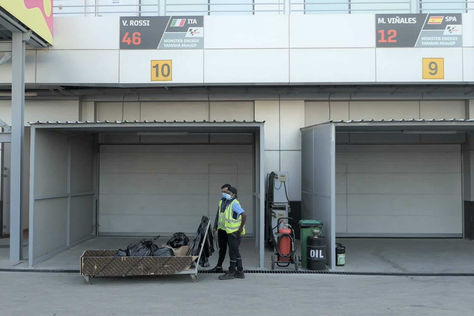 Workers clear out pit garages uring the 2020 MotoGP Qatar Grand Prix