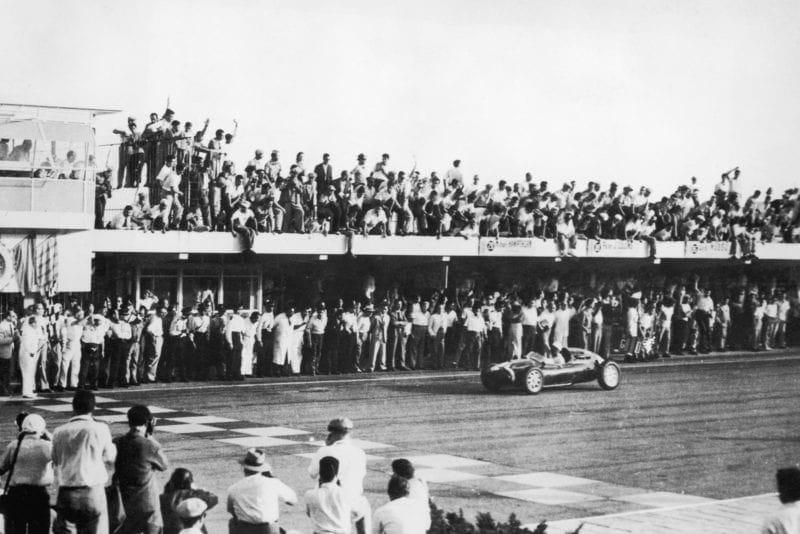 Stirling Moss crosses the line in Buenos Aires to win the 1958 Argentine Grand Prix in a Cooper-Climax T43