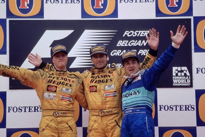 Damon Hill at the top of the podium with Ralf Schumacher and Jean Alesi after the 1998 Belgian Grand Prix
