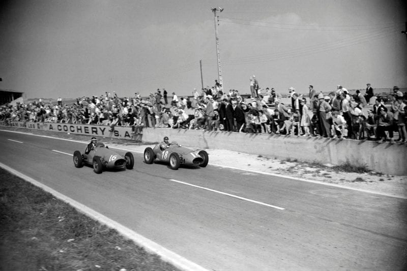 Mike Hawthorn passes Juan Manuel Fangio in the 1953 French Grand Prix