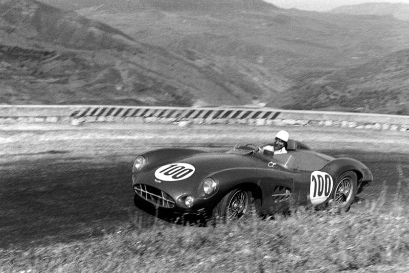 Stirling Moss climbs a hill in his Aston Martin DBR1 during the 1958 Targa Florio