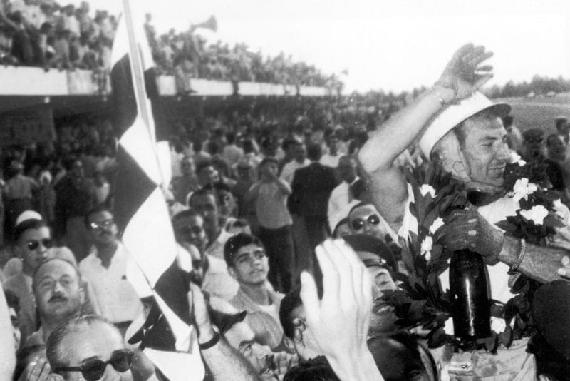 Stirling Moss celebrates victory in the 1958 Argentine Grand Prix